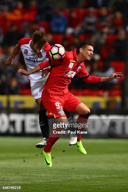 Aritz Borda of the Wanderers and Eli Babalj of Adelaide contest a header during the round 27 A-League match between Adelaide United and the Western...
