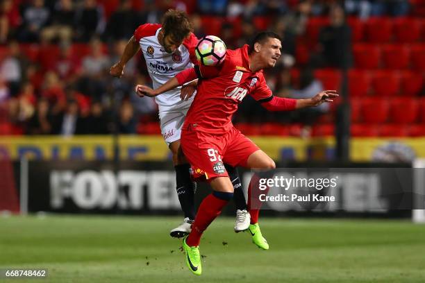 Aritz Borda of the Wanderers and Eli Babalj of Adelaide contest a header during the round 27 A-League match between Adelaide United and the Western...