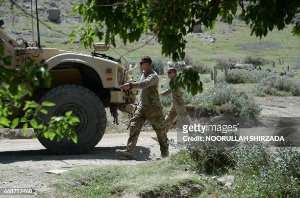 Soldiers patrol near the site of a US bombing during an operation against Islamic State militants in the Achin district of Afghanistan's Nangarhar...
