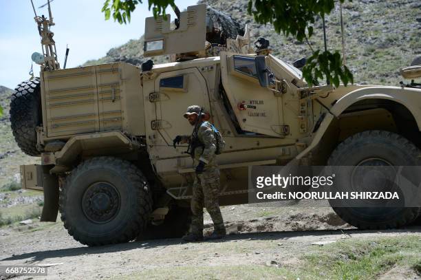 Soldier patrols near the site of a US bombing during an operation against Islamic State militants in the Achin district of Afghanistan's Nangarhar...