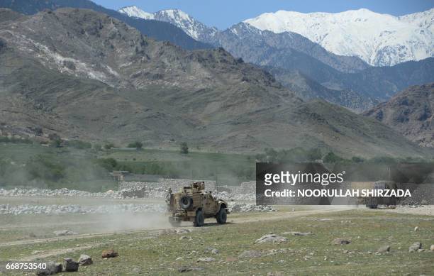 Armoured vehicles patrol near the site of a US bombing during an operation against Islamic State militants in the Achin district of Nangarhar...