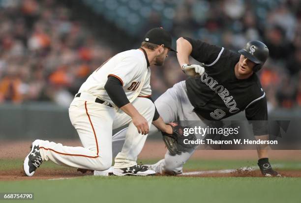 LeMahieu of the Colorado Rockies steals third base sliding under the tag of Conor Gillaspie of the San Francisco Giants in the top of the first...