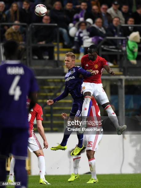 Lukasz Teodorczyk of Anderleht and Eric Bailly of Manchester United compete for the ball during the UEFA Europa League quarter final first leg match...