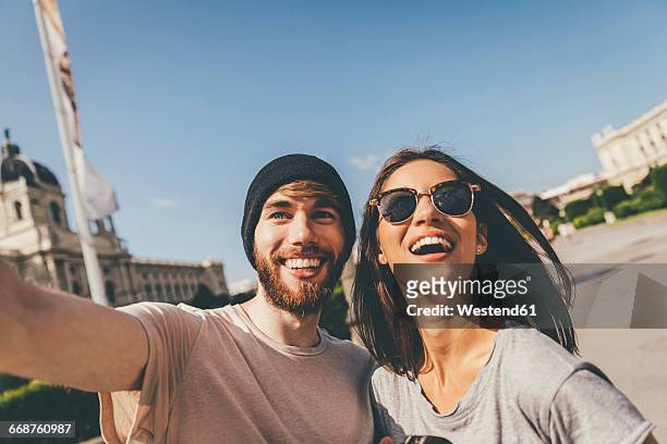 young couple taking selfie in vienna - städtereise stock-fotos und bilder