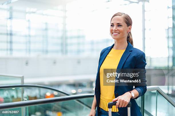 smiling woman at a station travelling - passengers 2016 film stock-fotos und bilder