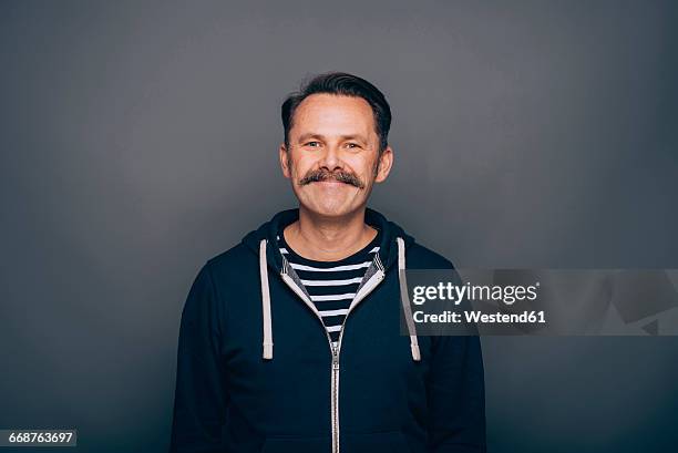 portrait of smiling man with moustache - schnurrbart stock-fotos und bilder