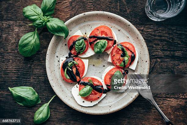 caprese salad with san marzano tomato and buffalo mozzarella and basil leaves - vinegar foto e immagini stock