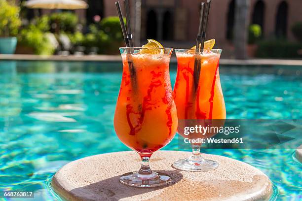 fruity cocktails floating on swimming pool - pool refreshment stock pictures, royalty-free photos & images