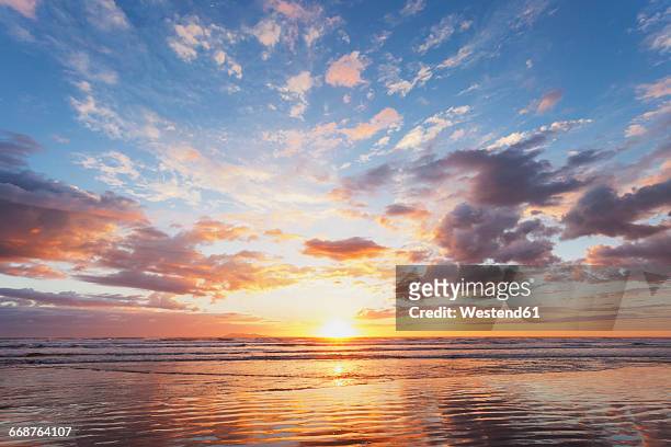 new zealand, north island, east coast sunrise, bay of plenty, waihi beach at sunrise, south pacific - morning stock pictures, royalty-free photos & images