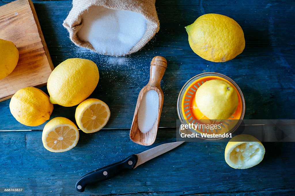 Ingredients to make lemonade on blue wood
