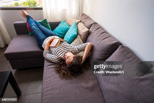 woman relaxing on couch - lazy day stock pictures, royalty-free photos & images