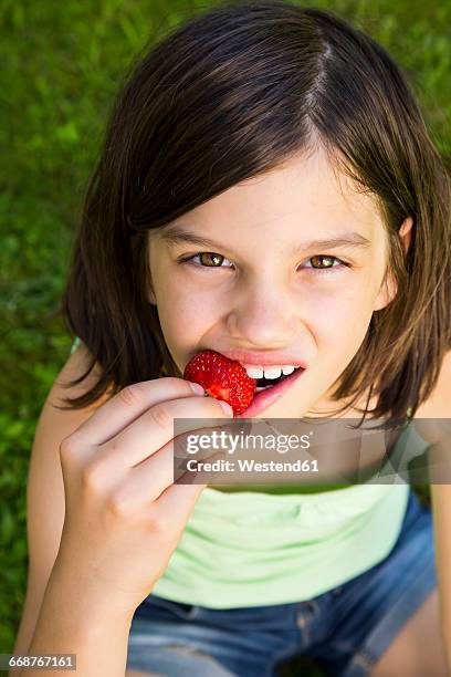 portrait of girl eating strawberry - girl with no mouth stock pictures, royalty-free photos & images