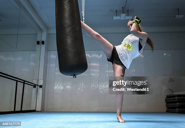 young woman kickboxing in gym - kickboxing stock pictures, royalty-free photos & images