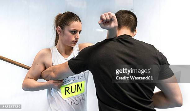 young woman in gym doing self defense training - 自衛 ストックフォトと画像