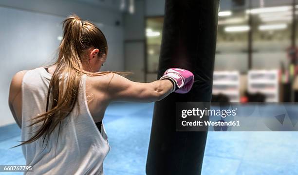 young woman boxing in gym - boxboll bildbanksfoton och bilder