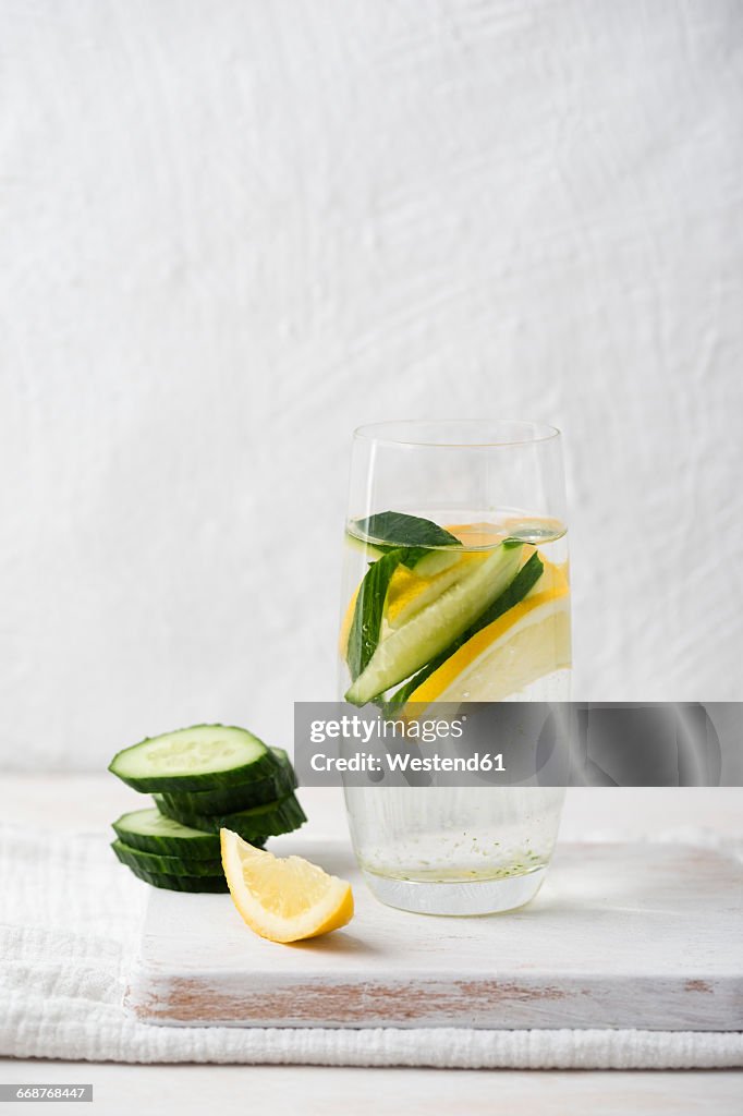 Glass of water flavoured with lemon and cucumber