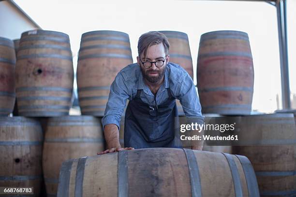 south africa, cape town, cooperage, cooper rolling wine barrel - rollup photos et images de collection