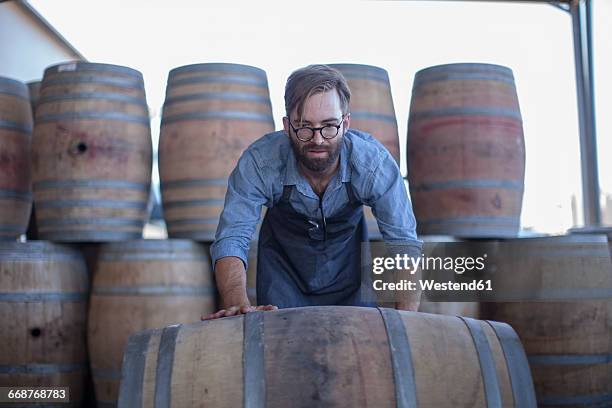 south africa, cape town, cooperage, cooper rolling wine barrel - cooper barrel stock pictures, royalty-free photos & images