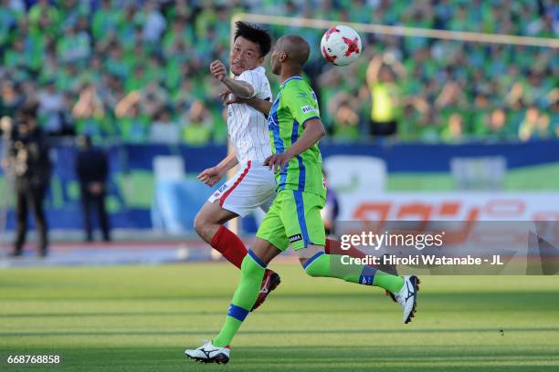 Daiki Tamori of FC Gifu heads the ball in front of Dinei of Shonan Bellmare during the J.League J2 match between Shonan Bellmare and FC Gifu at...