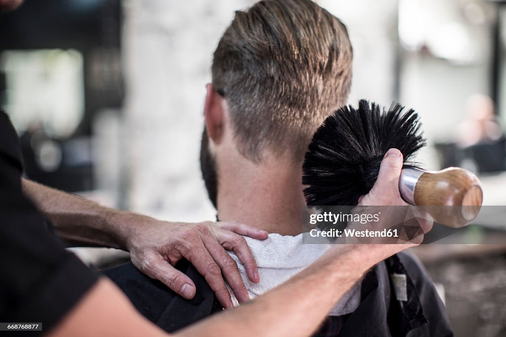 Barber brushing of customer