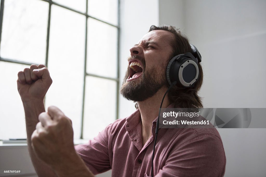 Man with headphones singing to music