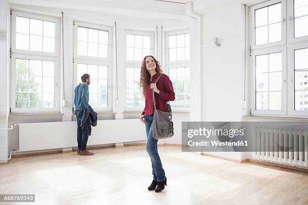 couple looking around in empty apartment - visit stock-fotos und bilder