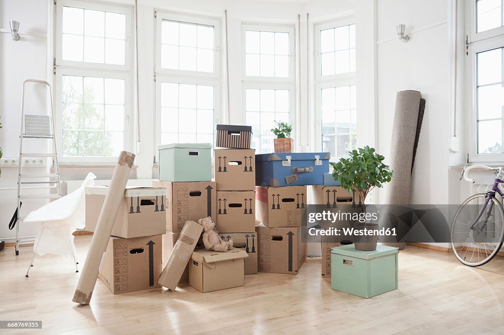 Stack of cardboard boxes in empty apartment