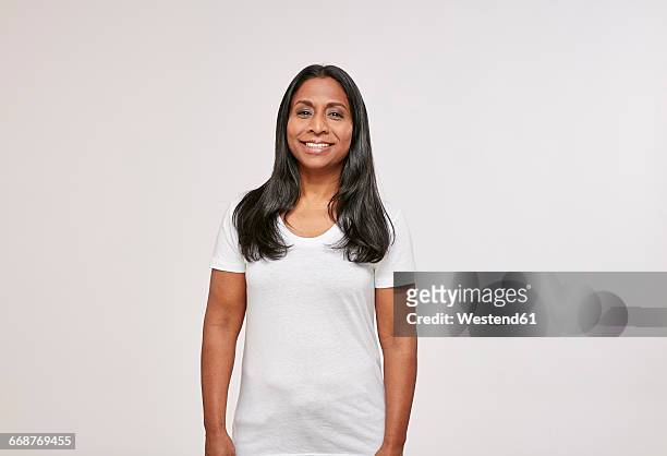 portrait of confident woman with black hair wearing white t-shirt - white t shirt studio stock pictures, royalty-free photos & images