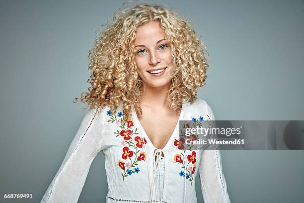 portrait of smiling blond woman with curly hair - ringlet curls stock pictures, royalty-free photos & images