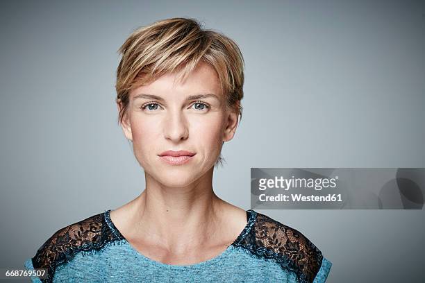 portrait of serious blond woman - short hair stock pictures, royalty-free photos & images