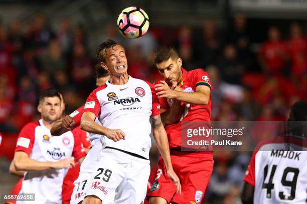Ryan Griffiths of the Wanderers and Iacopo La Rocca of Adelaide contest a header from a corner kick during the round 27 A-League match between...