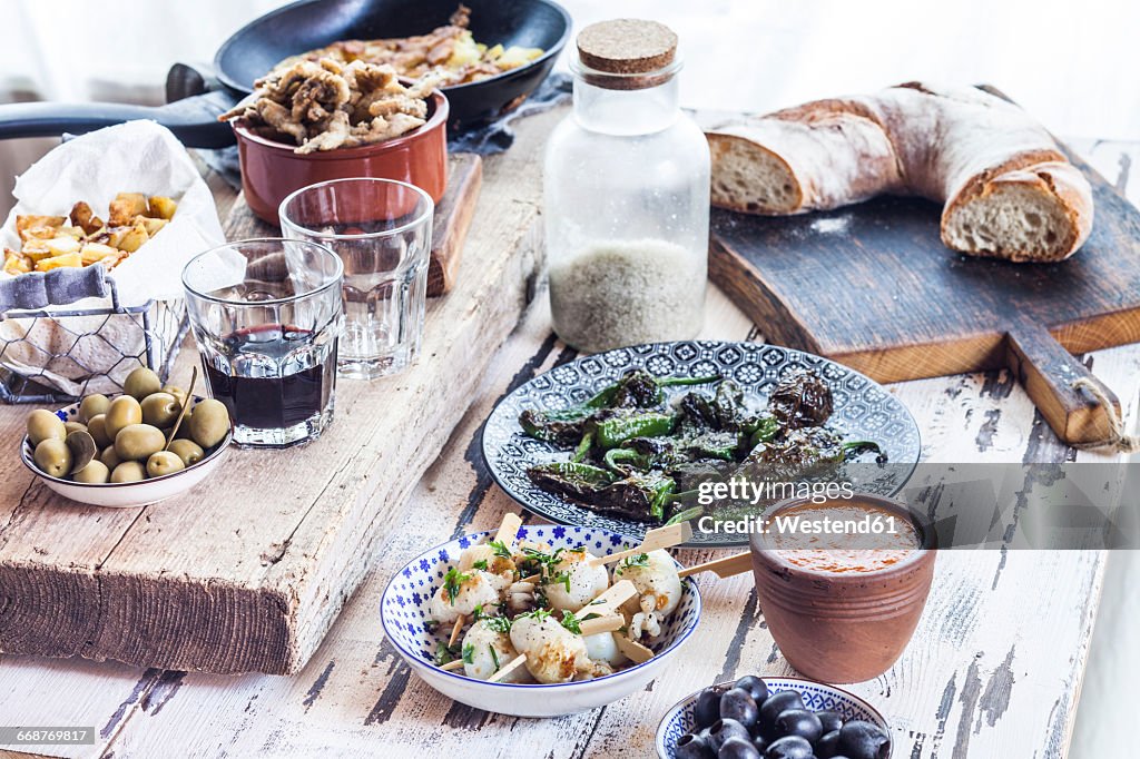 Grilled sepia, olives, pimientos de padron , Mojo sauce, patatas bravas, tortilla de patate, boquerones fritos, vino and bread