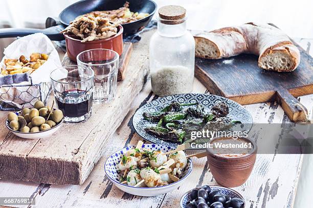 grilled sepia, olives, pimientos de padron , mojo sauce, patatas bravas, tortilla de patate, boquerones fritos, vino and bread - mojo stock pictures, royalty-free photos & images