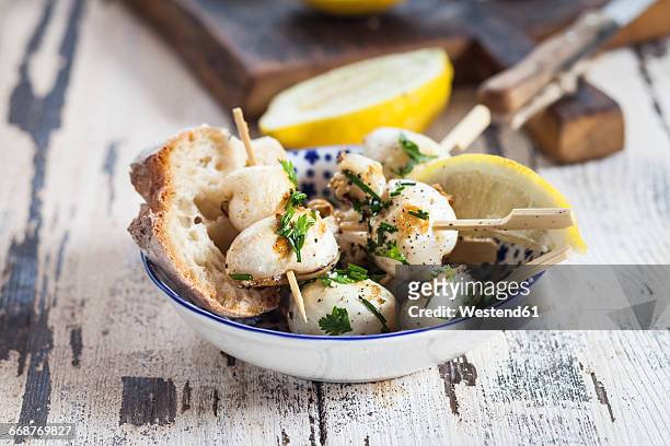 tapas, grilled sepia, lemon and bread in bowl - cuttlefish stock pictures, royalty-free photos & images