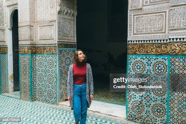 woman standing inside riad in morocco - morocco tourist stock pictures, royalty-free photos & images