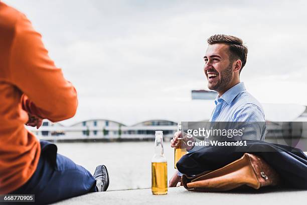 two colleagues having a beer after work - beer flowing stock pictures, royalty-free photos & images