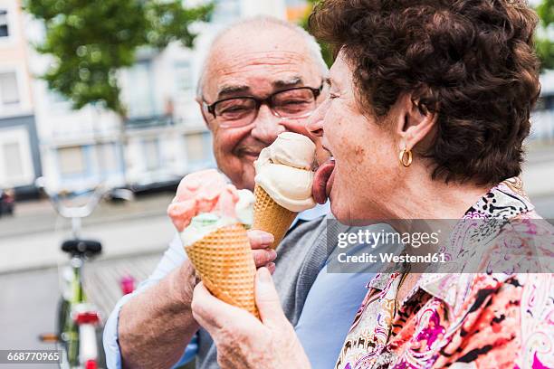 senior couple enjoy eating ice cream together - ice cream fotografías e imágenes de stock