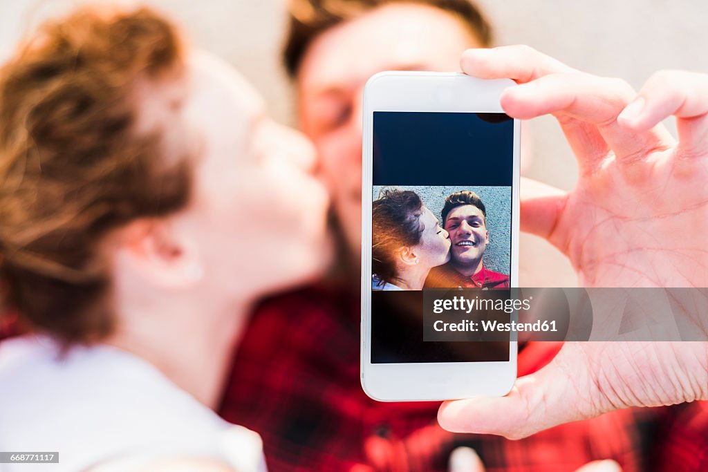 Selfie of young couple lying down
