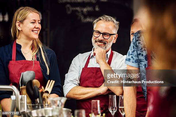 members of a cooking class having fun - cooking event stock pictures, royalty-free photos & images