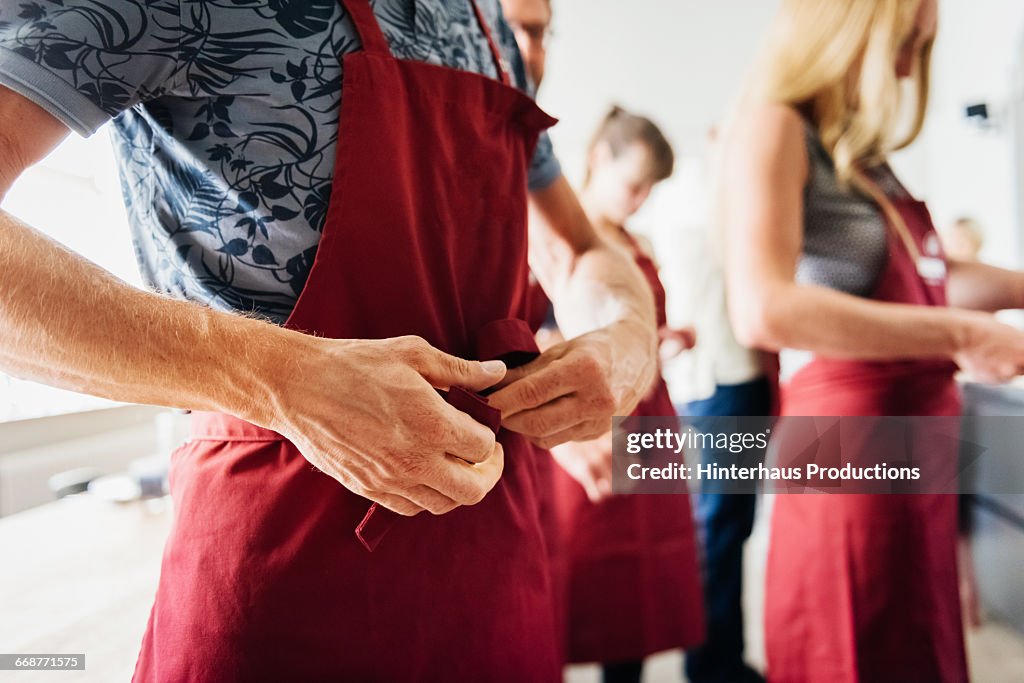 Tying an apron in a cooking class