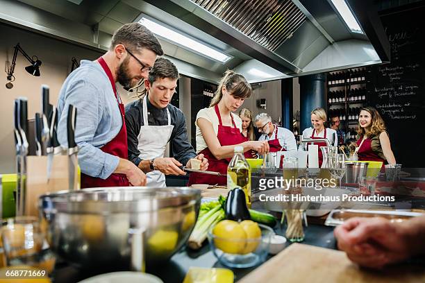 chef assisting a cooking class - cookery class stock-fotos und bilder