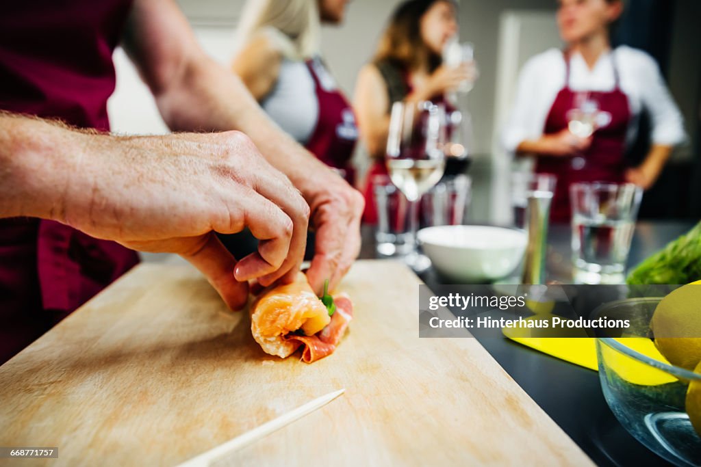 Hand folding meat in a cooking class