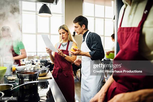 chef assisting members of a cooking class - 料理教室 ストックフォトと画像