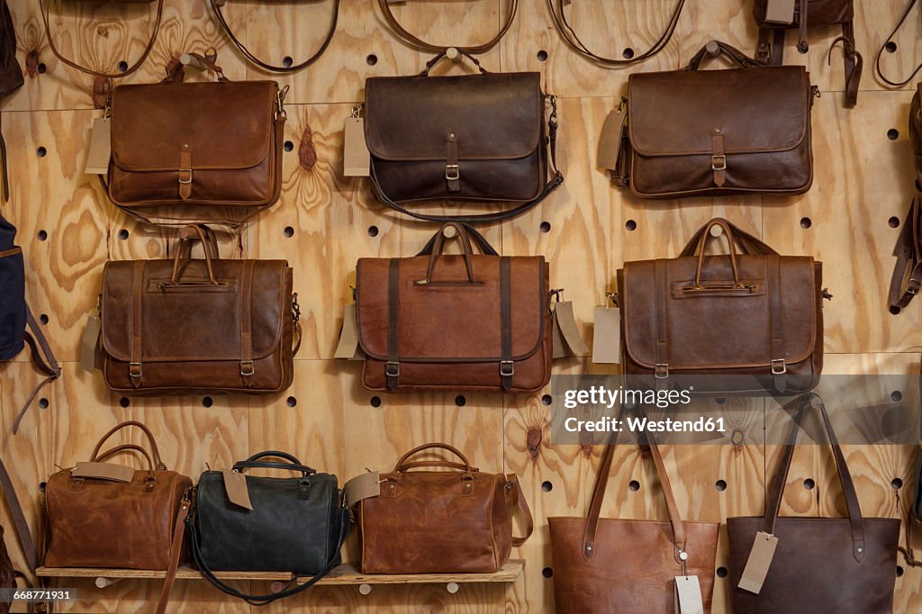 Leather bags hanging on wall