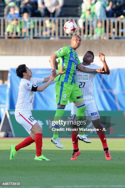 Dinei of Shonan Bellmare competes for the ball against Yoshihiro Shoji and Henik of FC Gifu during the J.League J2 match between Shonan Bellmare and...