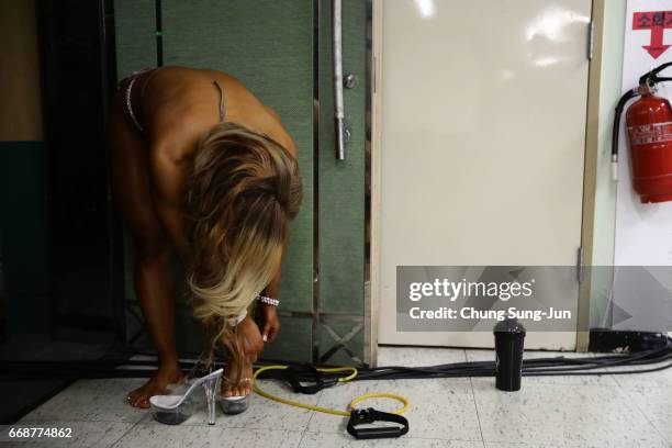 Female bodybuilder prepares herself for judging backstage during the 2017 NABBA WFF Asia Seoul Open Championship on April 15, 2017 in Seoul, South...