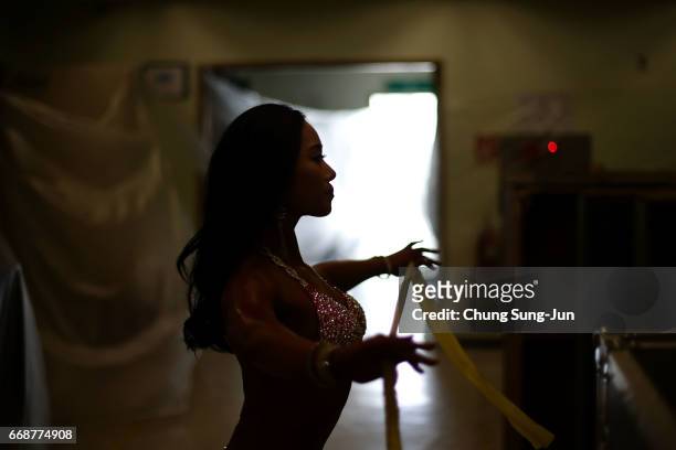 Female bodybuilder prepares herself for judging backstage during the 2017 NABBA WFF Asia Seoul Open Championship on April 15, 2017 in Seoul, South...