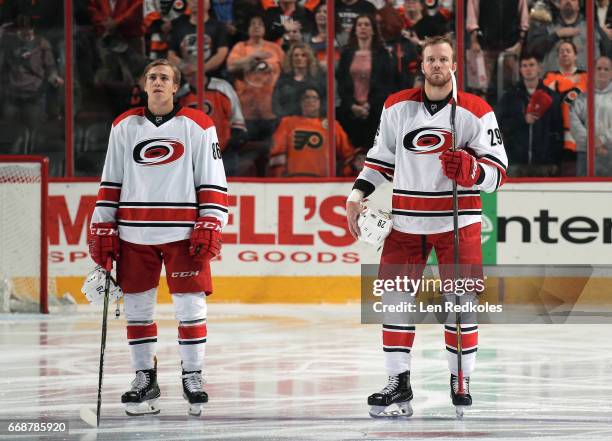 Bryan Bickell and Teuvo Teravainen of the Carolina Hurricanes stand on the blue line during the National Anthem prior to the start of their game...