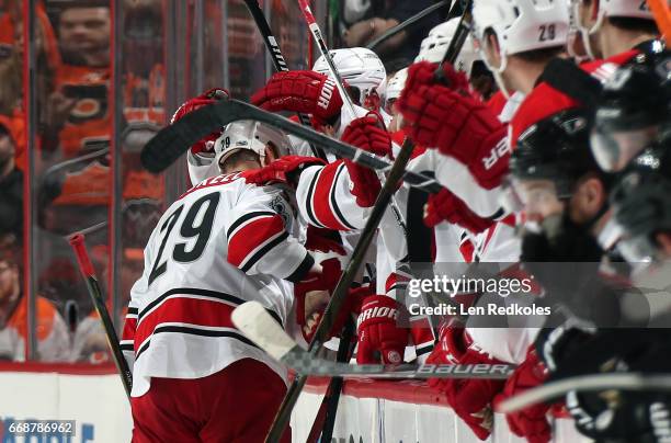 Bryan Bickell of the Carolina Hurricanes celebrates with his teammates on the bench after scoring a goal in the shootout against the Philadelphia...
