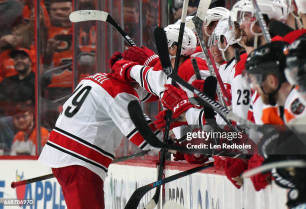 Bryan Bickell of the Carolina Hurricanes celebrates with his teammates on the bench after scoring a goal in the shootout against the Philadelphia...